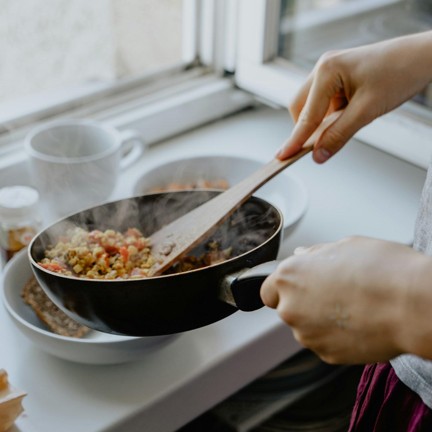 Community members collaborating in a modern kitchen space, exchanging recipes and techniques